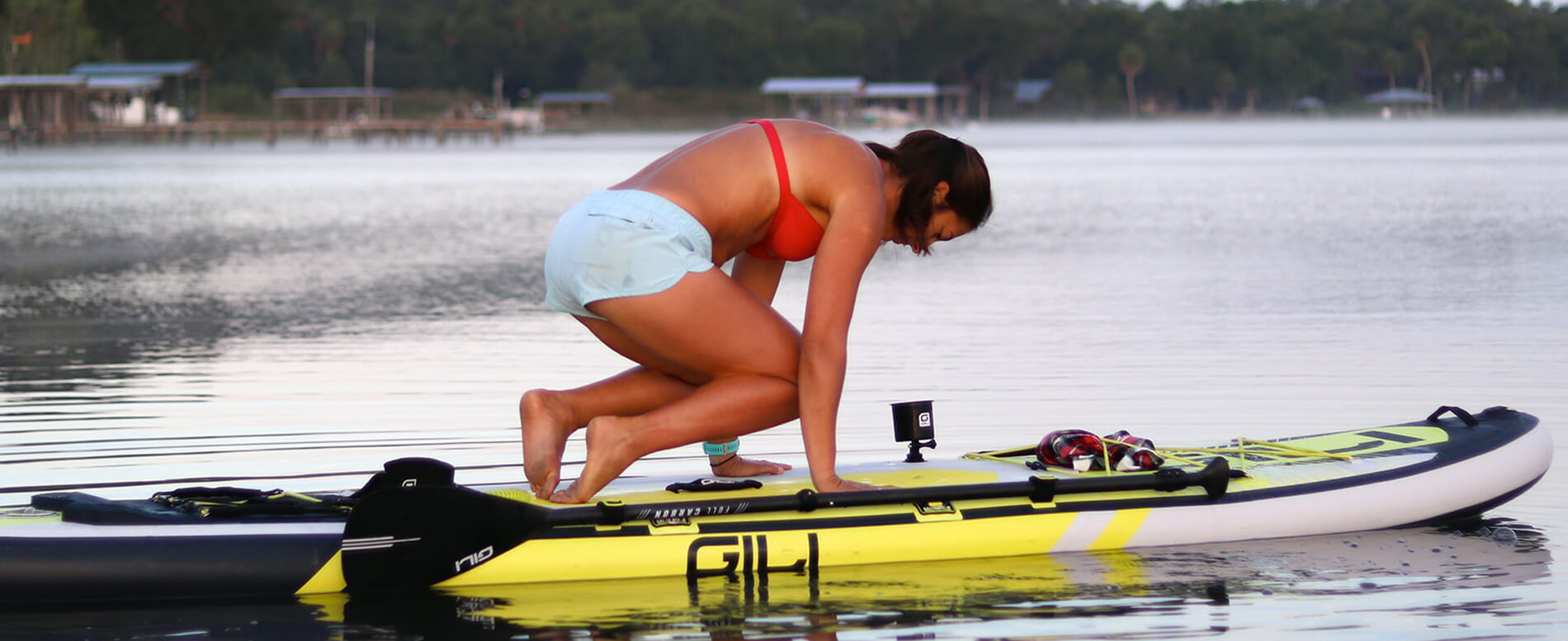 Women performing a Yoga on her yellow GILI inflatable paddle board