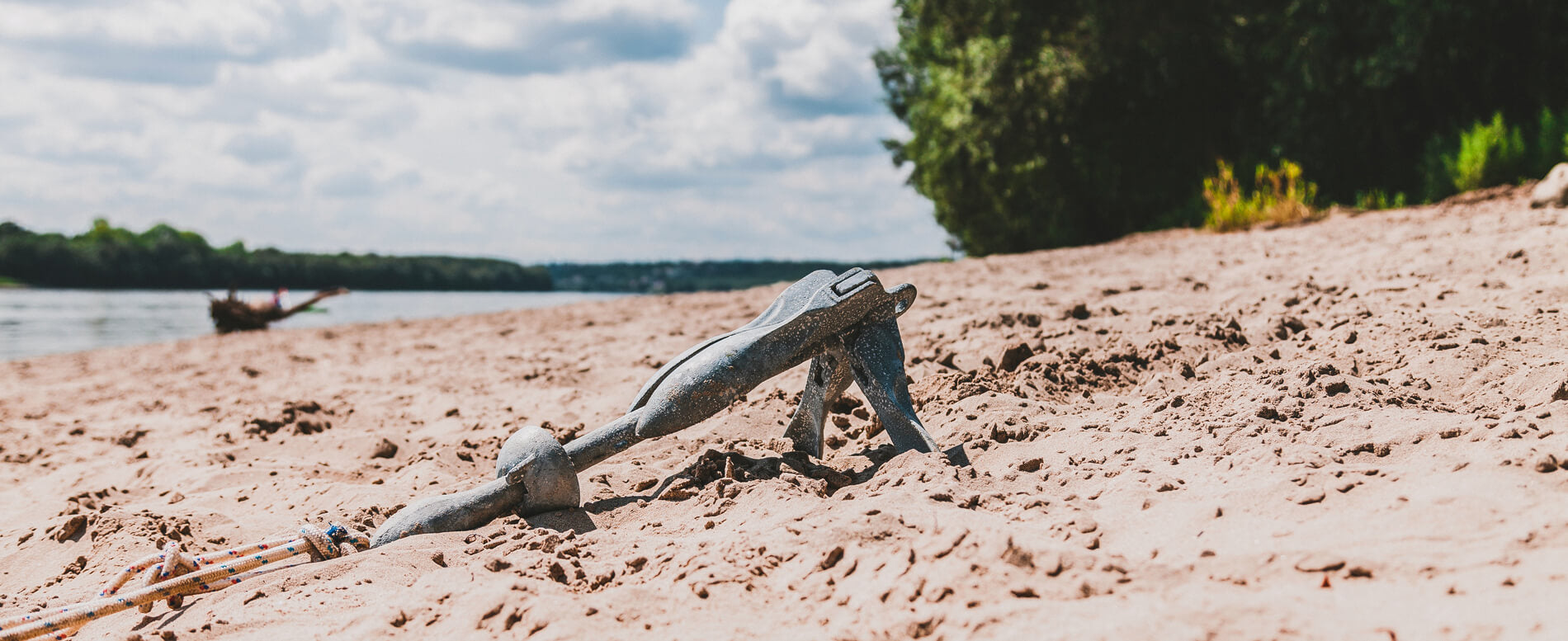 Galvanized grapnel anchor on sand