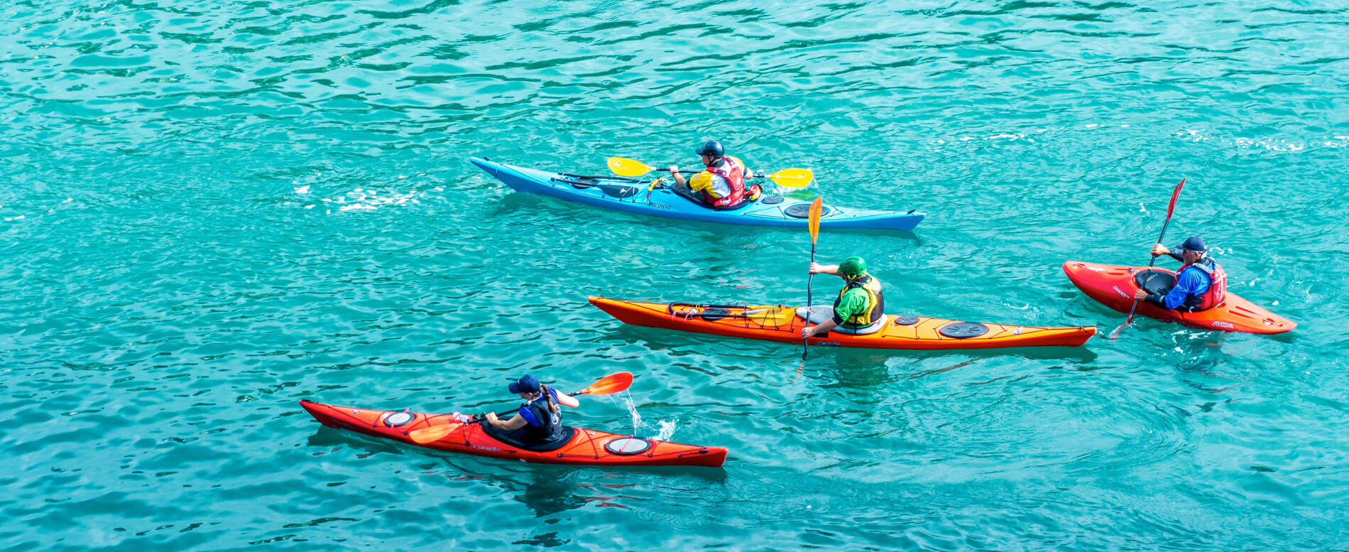 Four man kayaking using varied types of kayak
