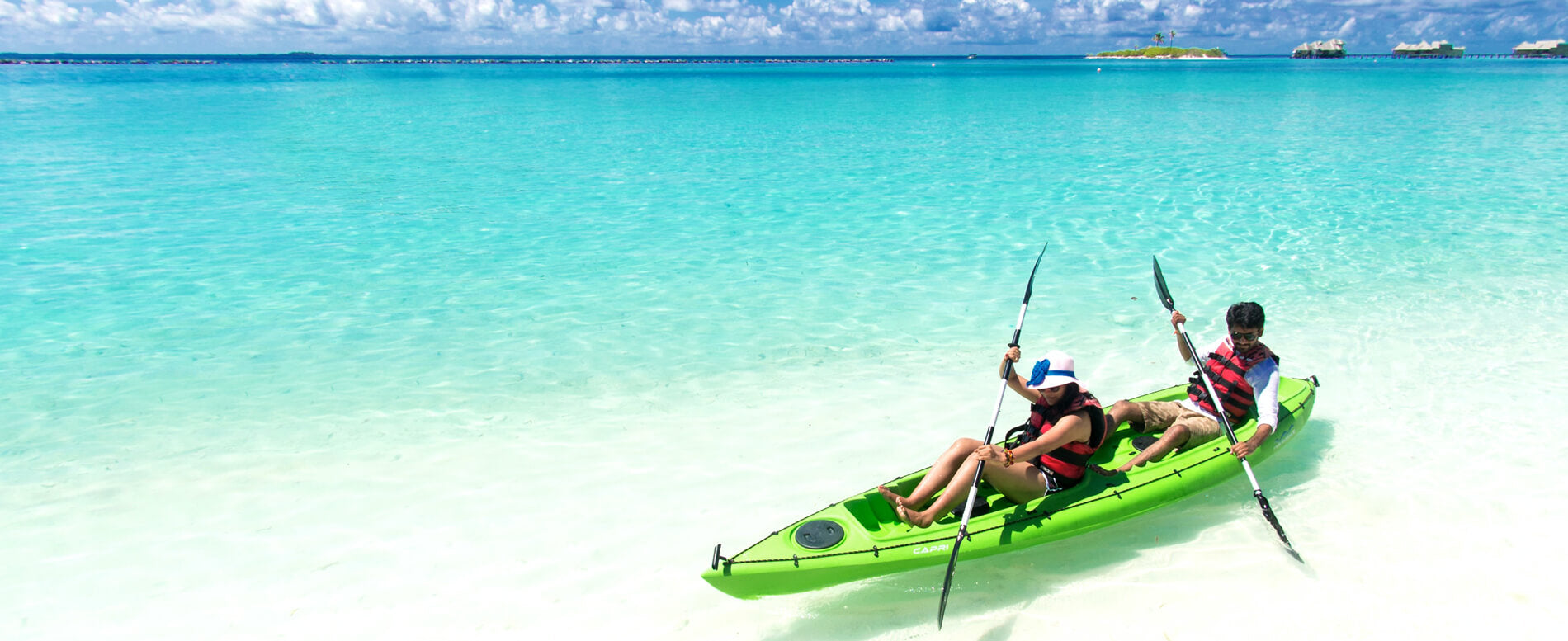 Man and a woman on a green sit on top kayak