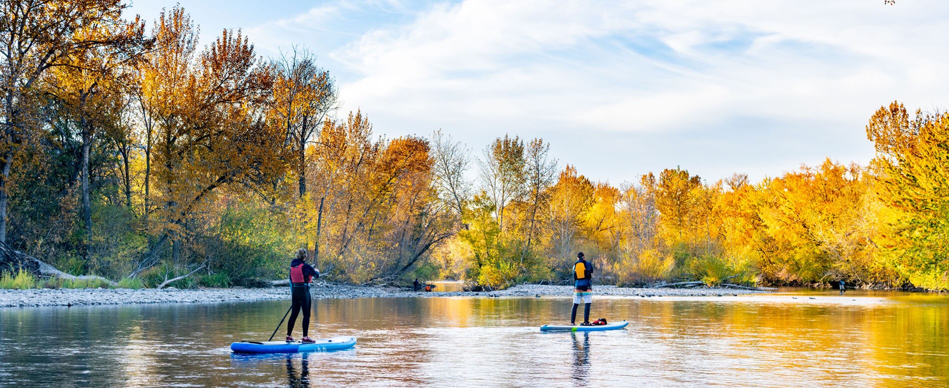 two man paddle boarders at boise river