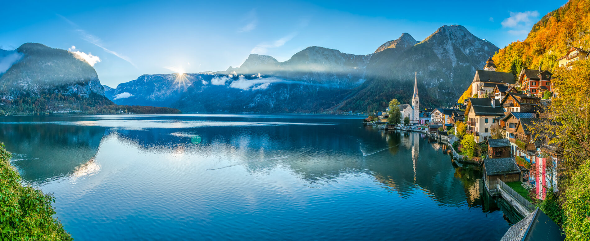 Scenic panoramic picture-postcard view of famous Hallstatt mountain village with Hallstatter See in the Austrian Alps