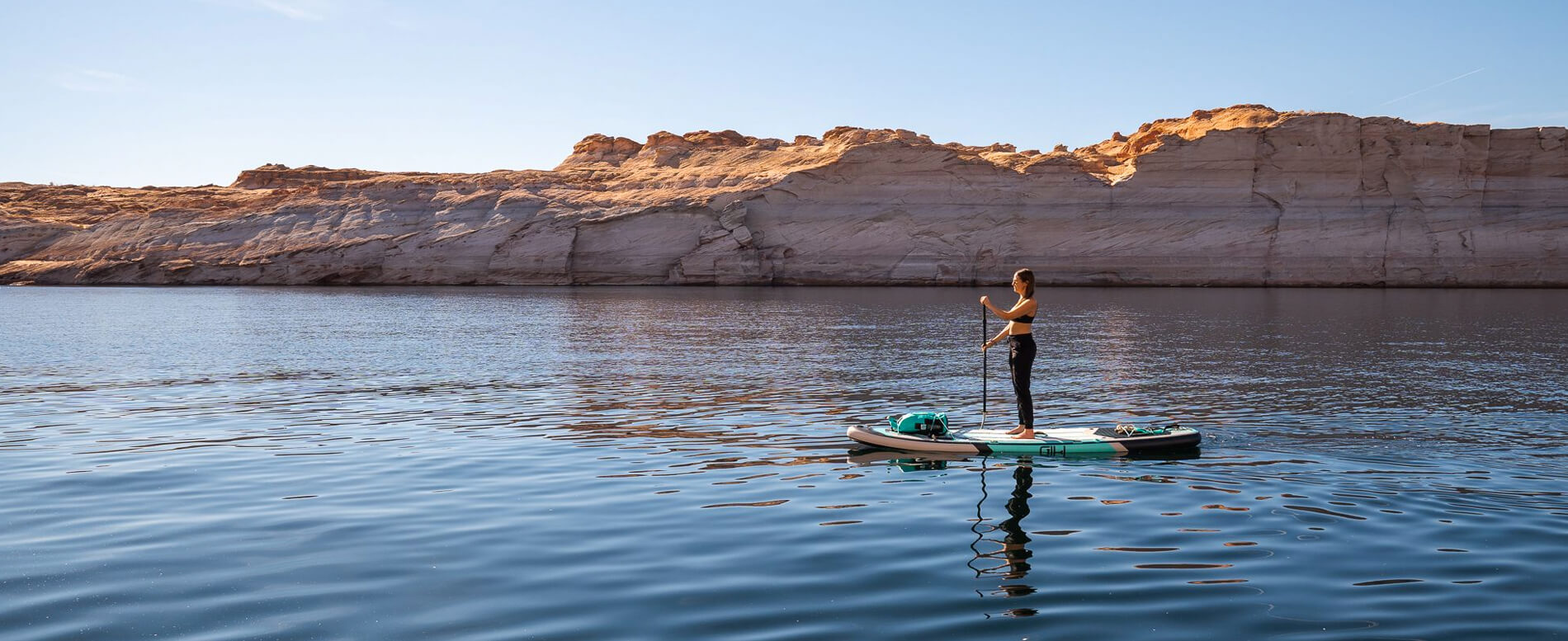 Woman paddle boarding on a calm water