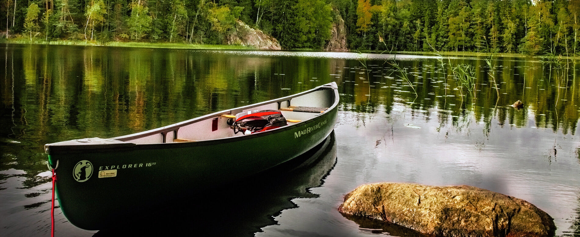 Explorer canoe on a crystal clear lake