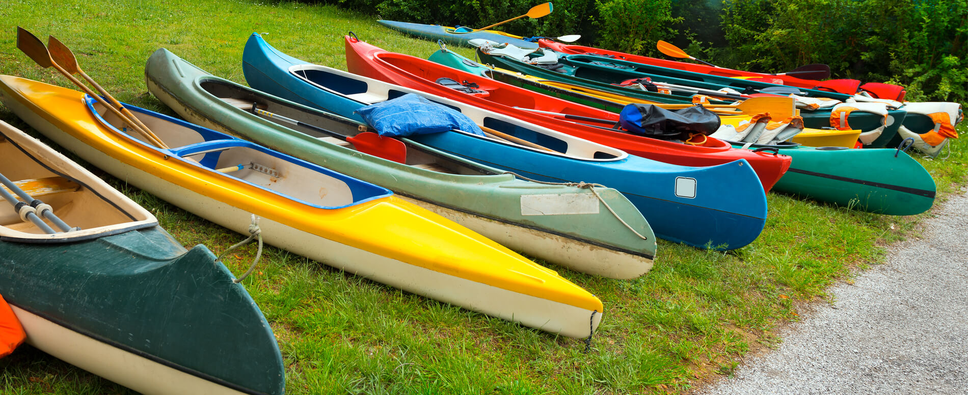 Different types of Canoe and Kayak on the ground