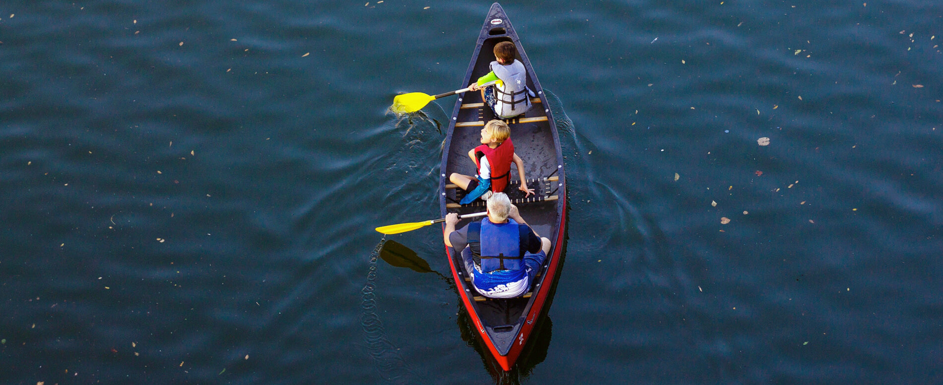 Family on a red canoe