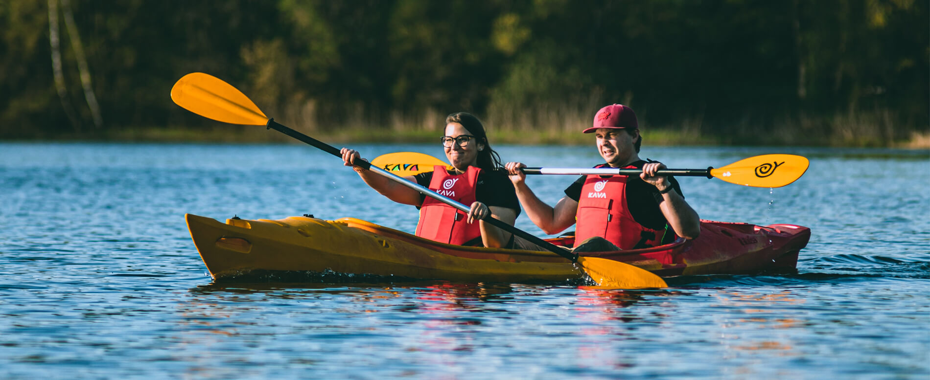 Man and a woman wearing a life jacket on a tandem kayak