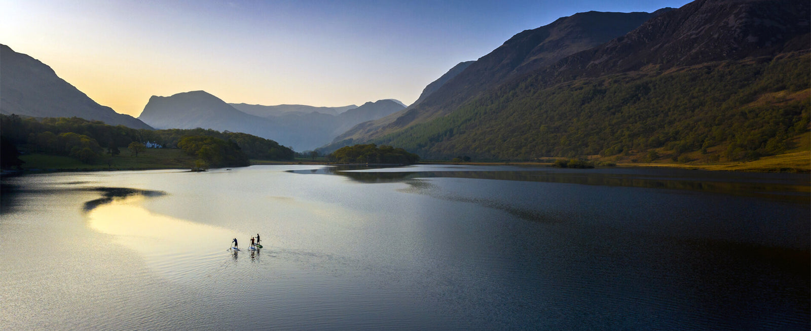 Early morning paddle boarders at Crummock water