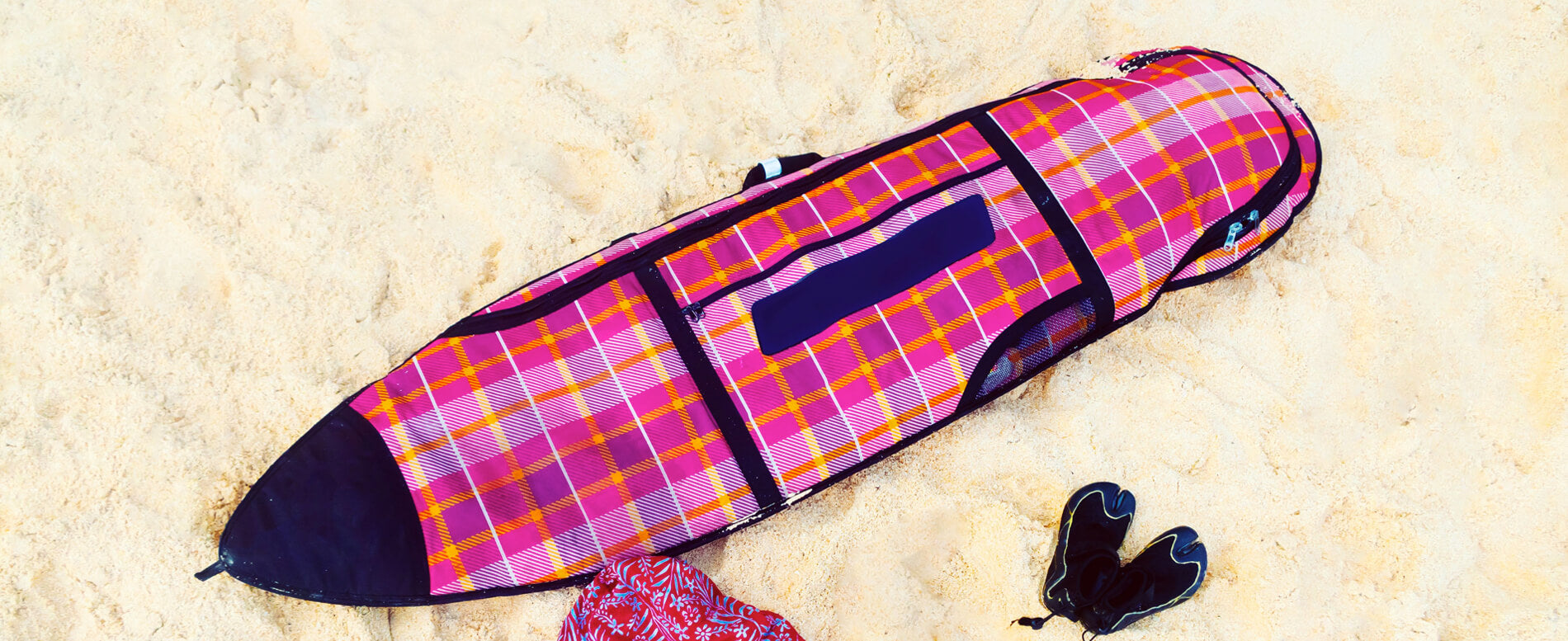 Pink surfboard bag on the beach