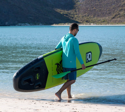 10'6 AIR Inflatable Paddle Board in Green at the beach
